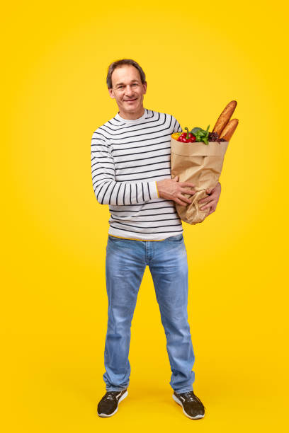 istock Middle aged man with grocery bag 1179404704