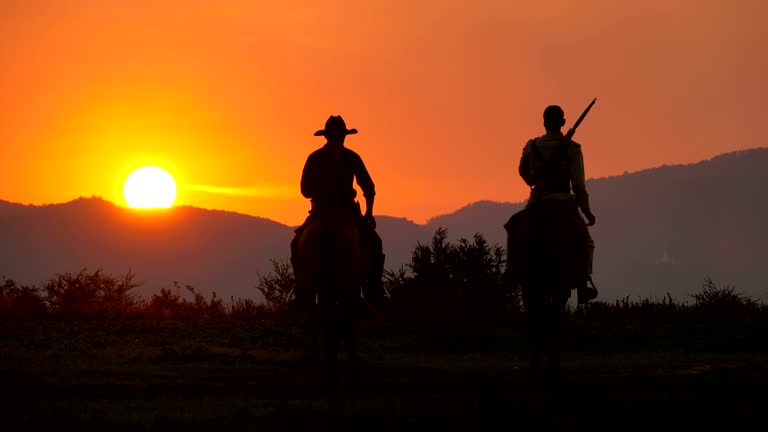 4K Soldier And Cowboy Riding Horses Walking Into The Sunset