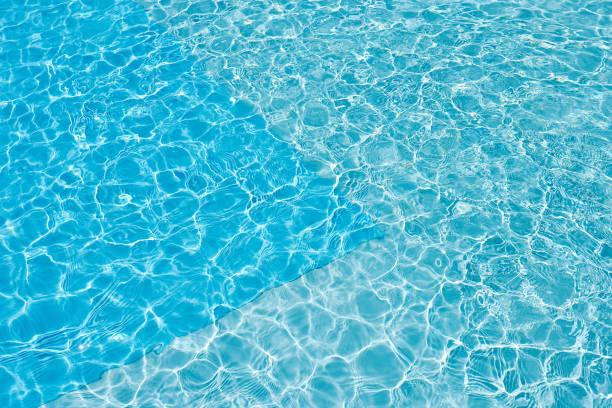 istock Background of water in blue swimming pool, water surface with a sun reflection 1179404950