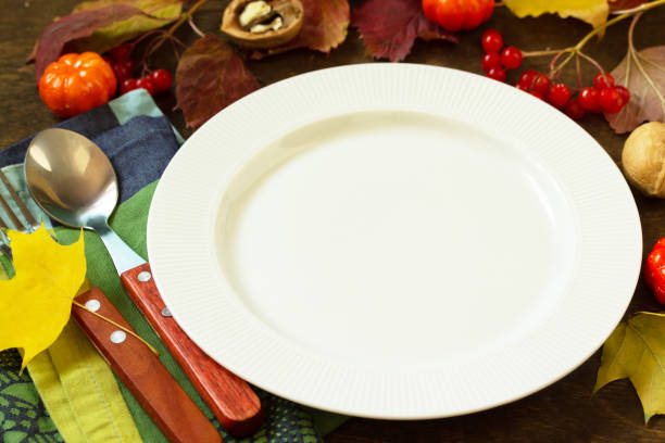 istock Autumn rustic table. Thanksgiving or autumn harvest table setting with rustic silver on a wooden table. Free space for your text. 1179406271