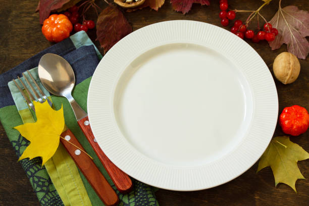 istock Autumn rustic table. Thanksgiving or autumn harvest table setting with rustic silver on a wooden table. Free space for your text. 1179406274