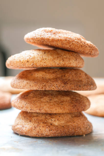 Snickerdoodles cookies (or sugar cookies) stacked on a baking tray. Vertical shot.