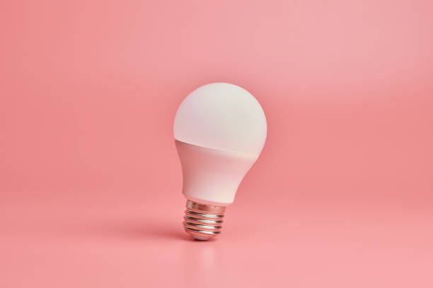 istock Light bulb, copy space. Energy saving minimal idea concept.Pink background. 1179407057