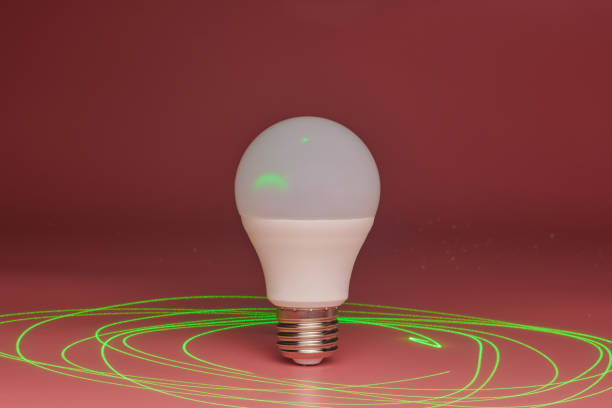 istock Energy saving light bulb, green laser beam around, copy space. Minimal idea concept. 1179407352