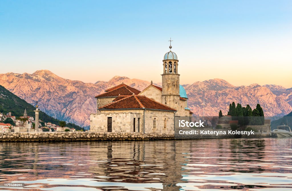 Dawn over island Dawn over Our Lady of the Rock island in Perast, Montenegro Kotor Stock Photo