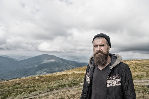 istock bearded handsome serious man on mountain top 1179408578