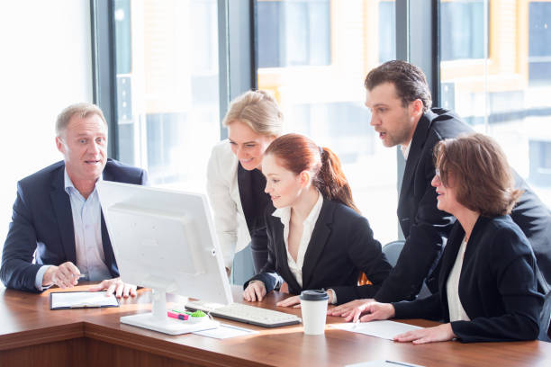 istock Business team look at one computer monitor 1179410331