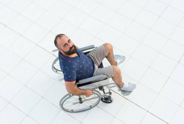 Disabled man in wheelchair looking up