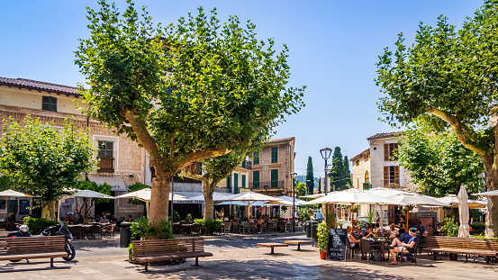 Soller, Mallorca, Spain, July 2015 Main city square with trees, beer gardens and restaurants, people relaxing and sightseeing