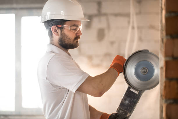 istock The industrial Builder works with a professional angle grinder to cut bricks and build interior walls. Electrician. 1179419812
