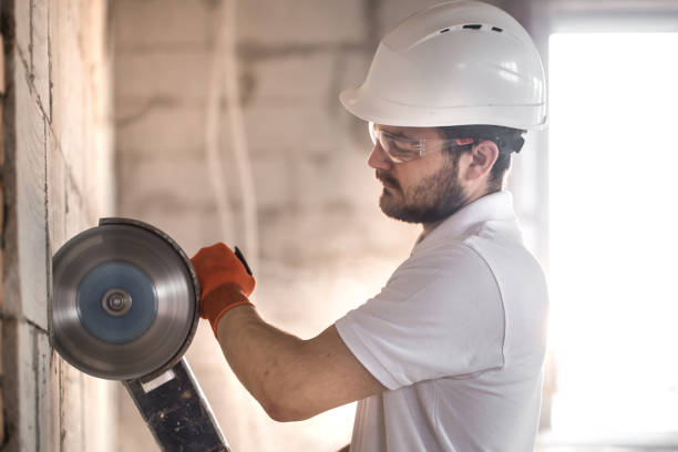 istock The industrial Builder works with a professional angle grinder to cut bricks and build interior walls. Electrician. 1179419820