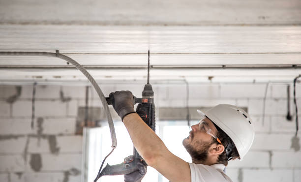 istock Handyman uses jackhammer, for installation, professional worker on the construction site. The concept of electrician and handyman. 1179419852