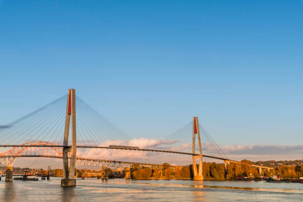 istock Bridges over the river with a moving train, clouds and a blue sky 1179420076