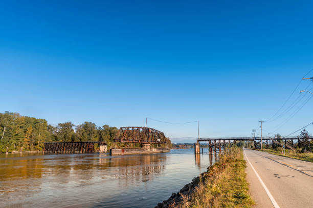 istock open movable railway bridge on the river between the asphalt road and the forest 1179420155