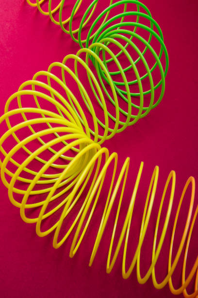 istock Toy plastic rainbow rings on Pink Background 1179421416