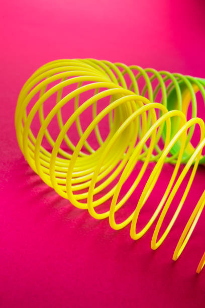 istock Toy plastic rainbow rings on Pink Background 1179421472