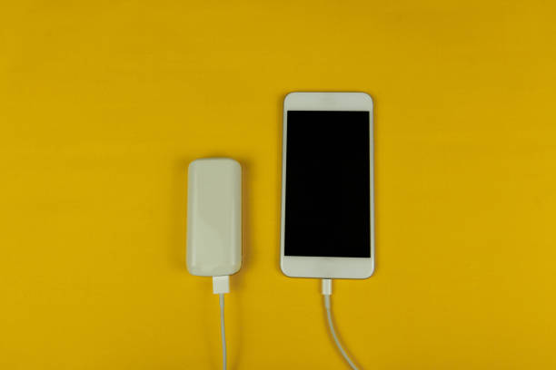istock Mobile and power bank on the yellow background. Space Text. 1179424018