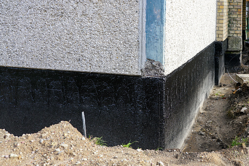 house foundation wall waterproofing and damp proofing with bitumen membrane