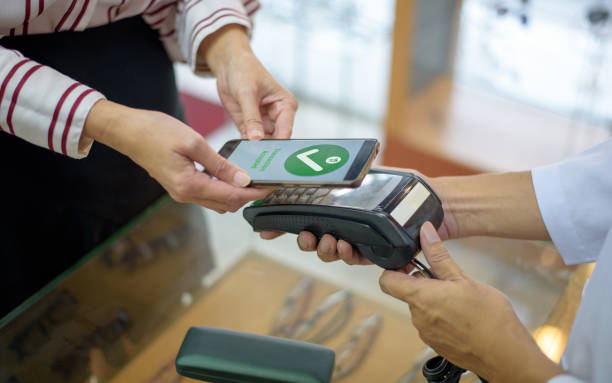 istock Woman Paying With Smartphone 1179430981
