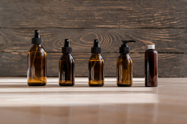 Cosmetic dark amber bottles on wooden  table stock photo