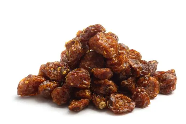 Dried goldenberries (Physalis peruviana), also known as a cape gooseberry and inca berries, in a pile, isolated on a white background.