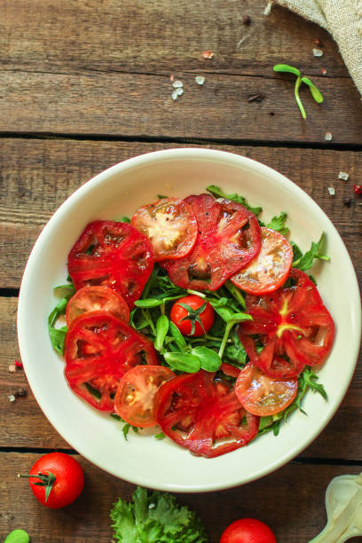 istock healthy salad tomatoes (vegetables, onions, greens, lettuce, sunflowers, microgreens and more) menu concept. food background. copy space. Top view 1179435530