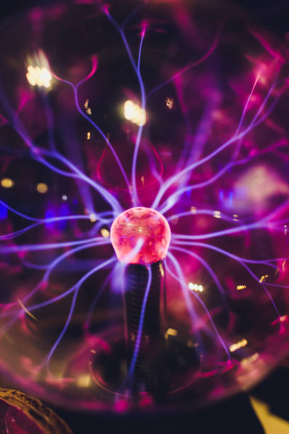 istock Hand touching a plasma ball with smooth magenta-blue flames. 1179436050