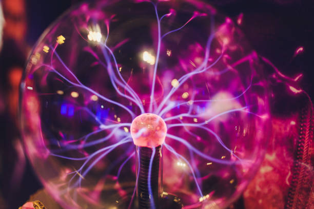 istock Hand touching a plasma ball with smooth magenta-blue flames. 1179436072