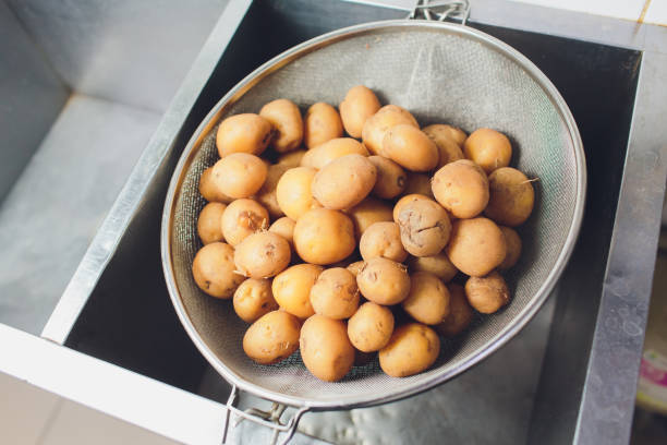 istock Young, small, whole fried potatoes. Golden fried. With garlic and greens. 1179439210