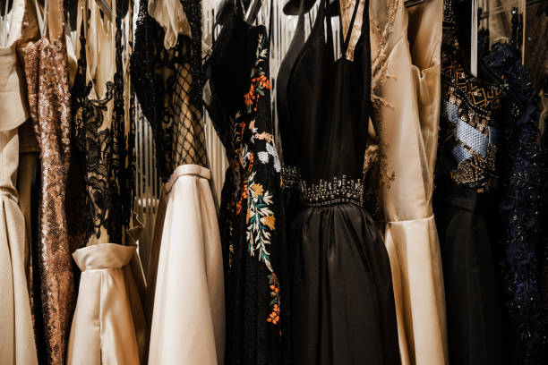 Luxury evening shining high fashion dresses Luxurious evening night out sparkling dresses hanging on the rack. High fashion concept, haute couture, designer prom fashion stock pictures, royalty-free photos & images