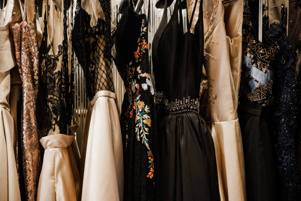 Luxury evening shining high fashion dresses Luxurious evening night out sparkling dresses hanging on the rack. High fashion concept, haute couture, designer garment store fashion rack stock pictures, royalty-free photos & images