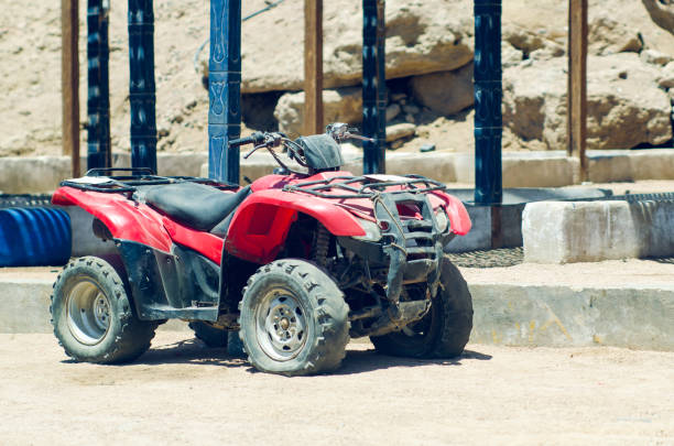 Man driving quad bike with girlfriend sitting behind and enjoying the ride in nature.