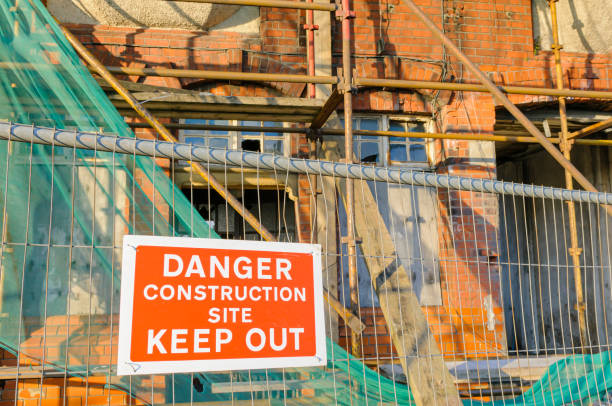 istock Building site with scaffolding, and site fencing with sign 