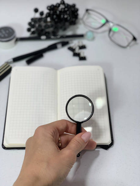 istock Auditor's desk, magnifying glass in hand. 1179444387
