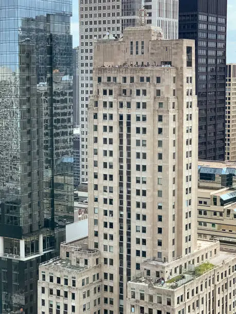 Photo of Crowds of people gather on a rooftop deck and a mid-building deck to watch the air & water show