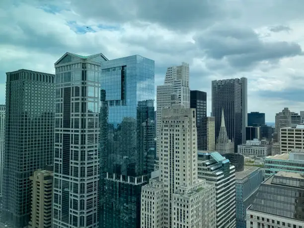 Photo of Aerial view of a military jet over Chicago Loop skyscrapers on cloudy afternoon