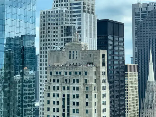 Photo of Crowd of people on rooftop deck gather to watch the air &  water show in Chicago Loop