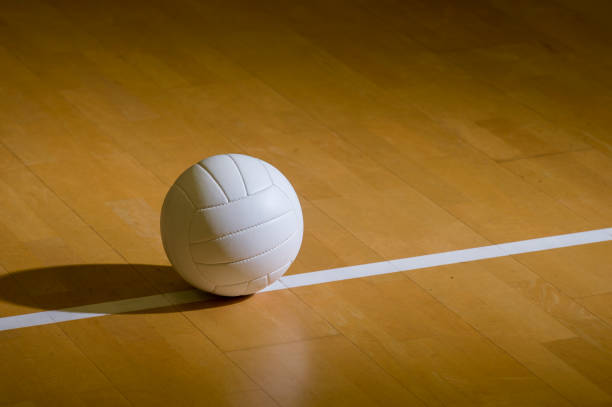 Volleyball court wooden floor with ball on black with copy-space Volleyball court wooden floor with ball on black with copy-space volleyball stock pictures, royalty-free photos & images