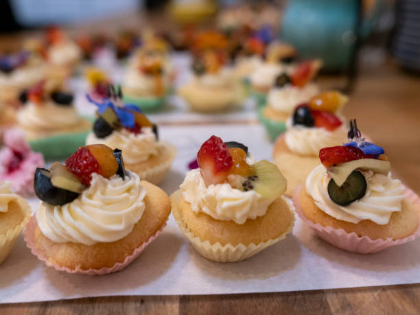 Beautiful and colourful sponge cupcakes laid out in a row