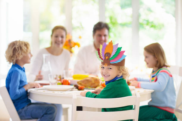 istock Family with kids at Thanksgiving dinner. Turkey. 1179449281
