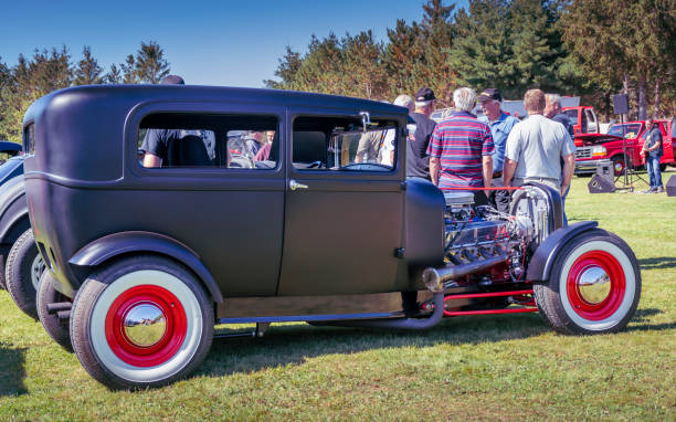 1929 Ford Model A sedan hot rod Hilden, Nova Scotia, Canada - September 21, 2019 :  Traditional styled hot rod based on a 1929 Ford Model A sedan, Scotia Pine Show & Shine at Scotia Pine Campground. A group of men stand near the hot rod and socialize. 1920 1929 stock pictures, royalty-free photos & images