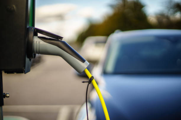 istock Electric Vehicle is changing in street. 1179450457