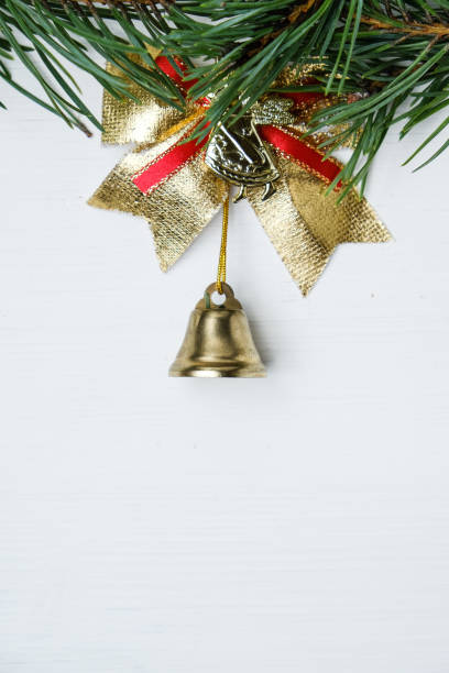 istock Christmas bell with bow and pine branch on background with copy space. 1179451561