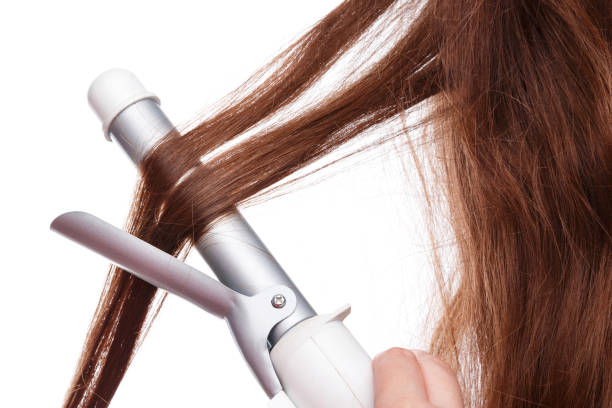 istock Curling iron and hair 1179452480