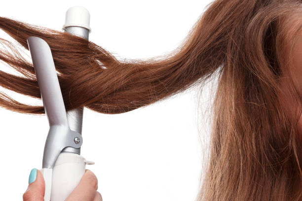 istock Curling iron and hair 1179452489