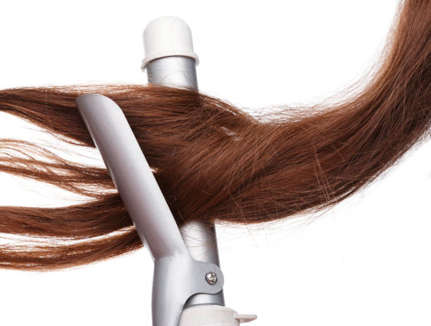 istock Curling iron and hair 1179454093