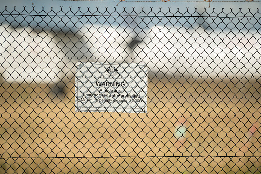 Brisbane, Australia July 26, 2019 A Commonwealth of Australia security sign on the fence at Brisbane Airport, warning of penalties for trespassing..