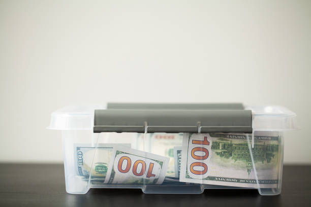 istock Donate box with dollars on wood desk 1179456834