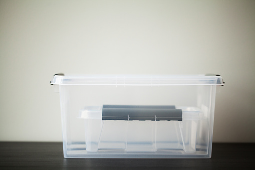 Transparent drawers for storing things on a wooden table.