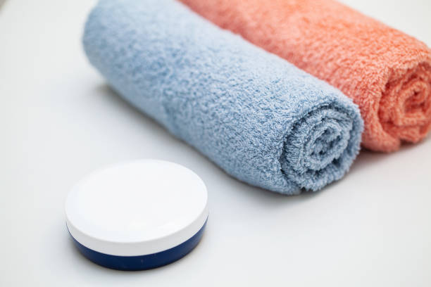 istock Color towels on white table with copy space on bath room background 1179460615